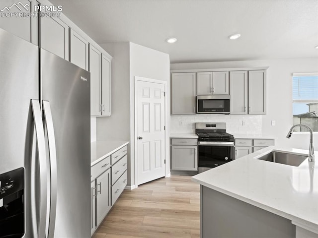 10434 Devoncove Dr, Peyton, CO 80831 - kitchen with a sink, appliances with stainless steel finishes, gray cabinets, and light countertops