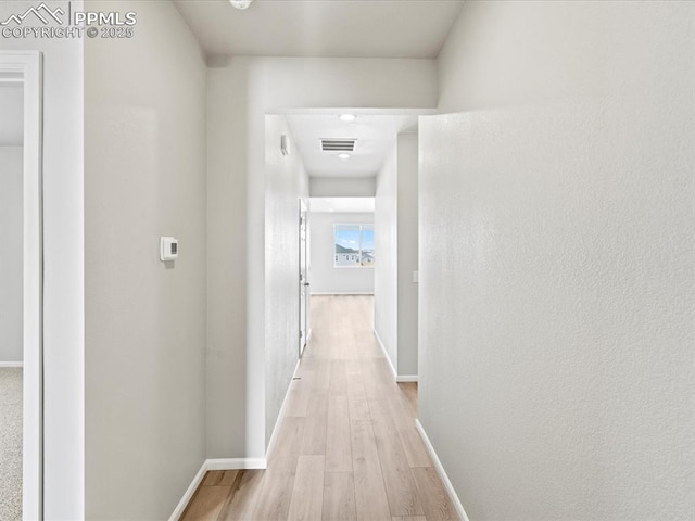 10434 Devoncove Dr, Peyton, CO 80831 - hall featuring visible vents, light wood-type flooring, and baseboards