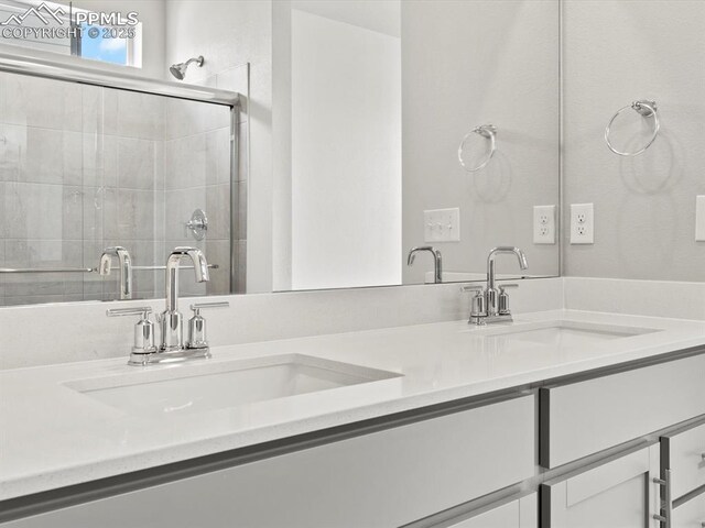 10434 Devoncove Dr, Peyton, CO 80831 - full bathroom with double vanity, a stall shower, and a sink