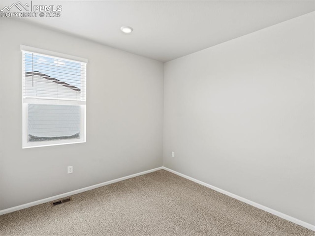 10434 Devoncove Dr, Peyton, CO 80831 - spare room featuring visible vents, baseboards, and carpet
