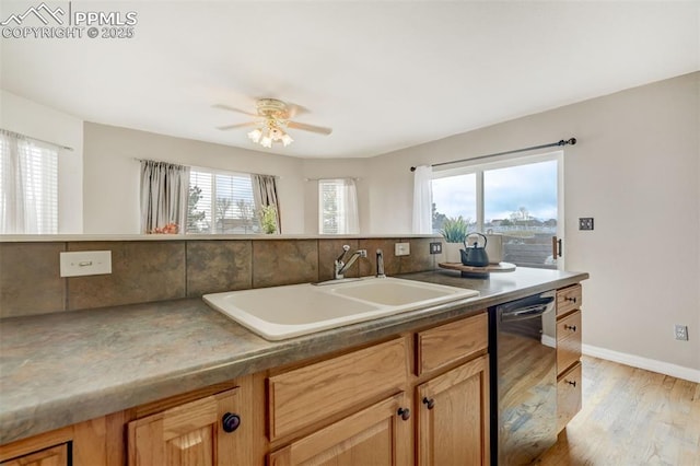 kitchen with sink, stainless steel dishwasher, ceiling fan, decorative backsplash, and light hardwood / wood-style floors