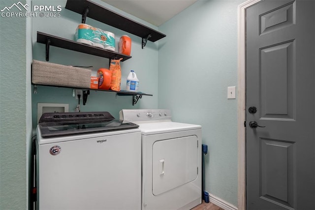 clothes washing area with separate washer and dryer