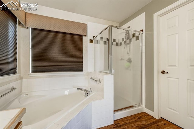 bathroom featuring hardwood / wood-style floors and independent shower and bath