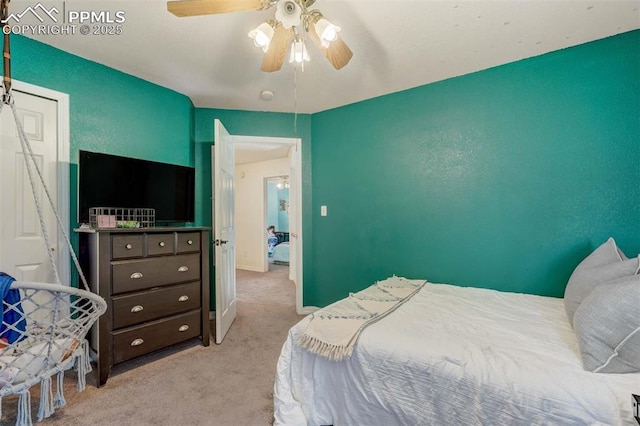 carpeted bedroom featuring ceiling fan