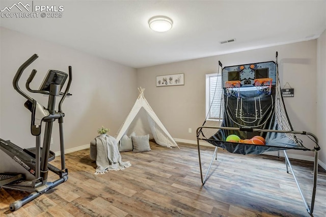 exercise area featuring hardwood / wood-style floors