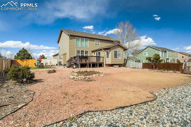 rear view of property featuring a wooden deck