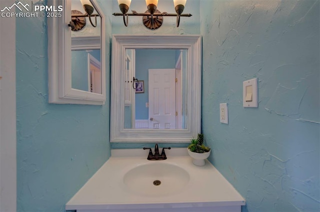 bathroom featuring a chandelier and vanity