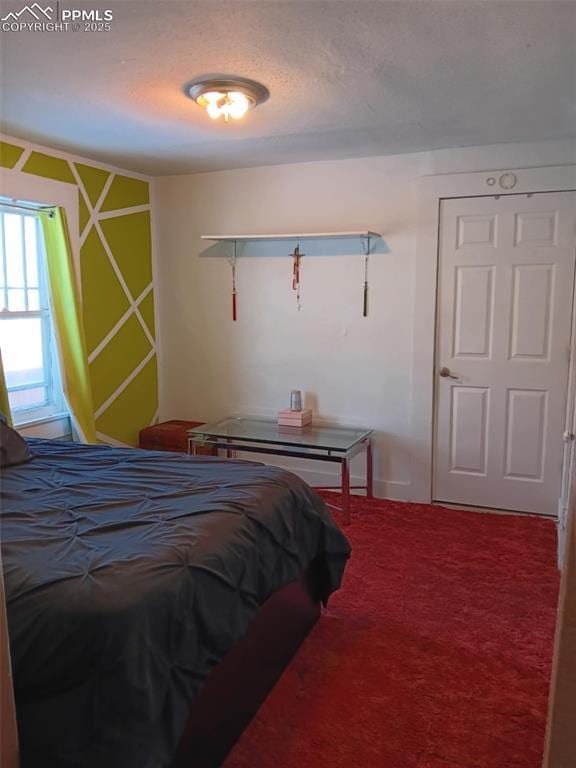 carpeted bedroom featuring a textured ceiling