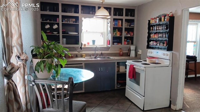 kitchen featuring sink, dark tile patterned flooring, white range with electric stovetop, and decorative light fixtures