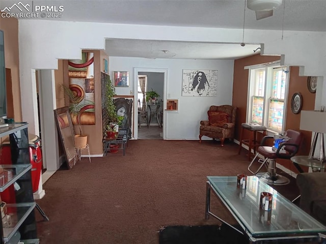 living area with dark colored carpet