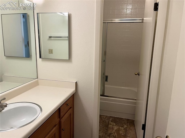 bathroom with vanity and bath / shower combo with glass door