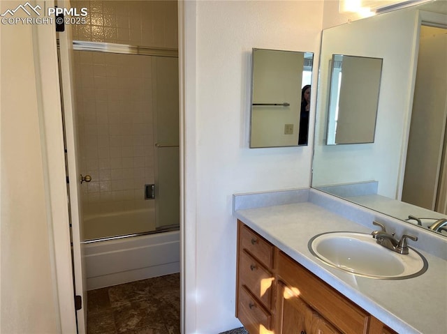 bathroom with vanity and shower / bath combination with glass door