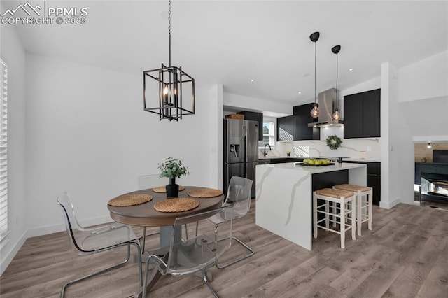 dining room featuring a chandelier and light wood-type flooring