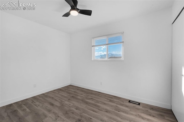 empty room with ceiling fan and wood-type flooring