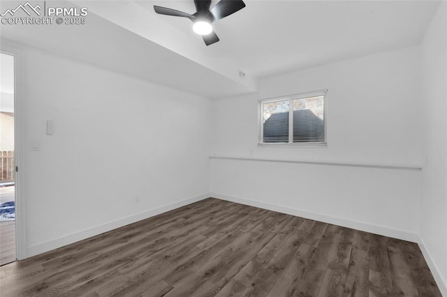 empty room featuring ceiling fan and dark hardwood / wood-style floors