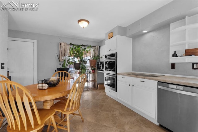 kitchen with white cabinets and appliances with stainless steel finishes