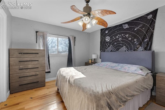 bedroom with ceiling fan and light hardwood / wood-style floors