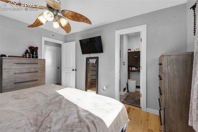 bedroom with ceiling fan, light hardwood / wood-style flooring, and ensuite bath