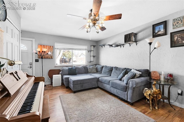 living room with ceiling fan and hardwood / wood-style floors