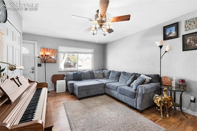 living room with ceiling fan and hardwood / wood-style floors