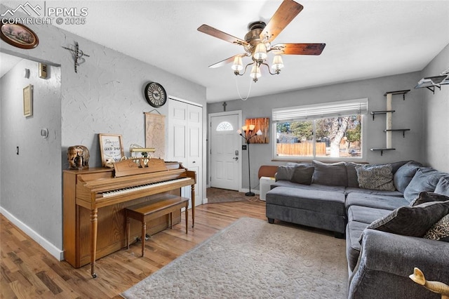 living room featuring ceiling fan and wood-type flooring