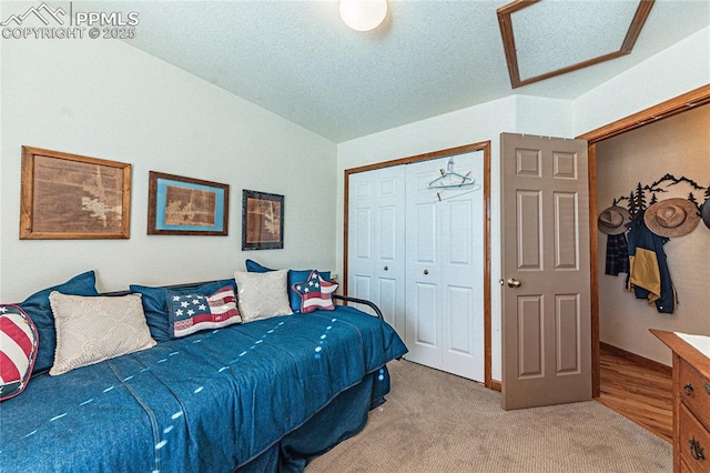 carpeted bedroom featuring a closet and a textured ceiling