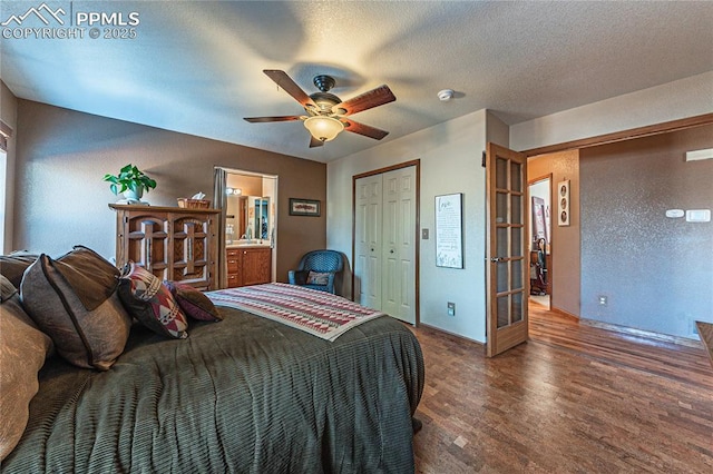 bedroom featuring ensuite bathroom, a textured ceiling, french doors, ceiling fan, and dark hardwood / wood-style flooring