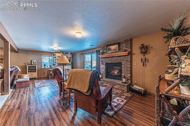 living room with a textured ceiling, dark wood-type flooring, and a fireplace