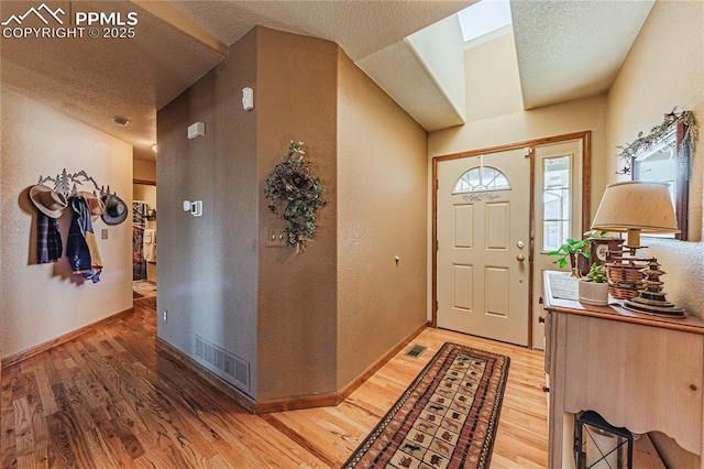 foyer with a textured ceiling and hardwood / wood-style floors