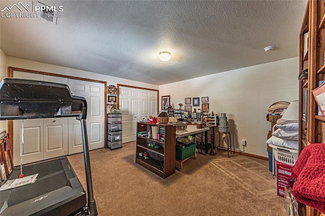 carpeted office featuring a textured ceiling