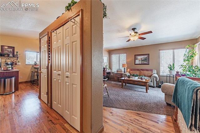 hall with a textured ceiling and hardwood / wood-style floors