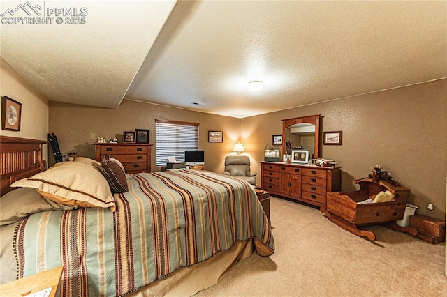 bedroom with a textured ceiling and carpet