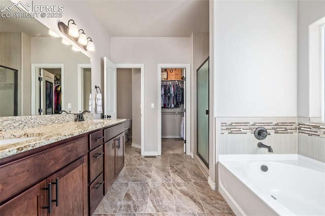 bathroom with vanity and separate shower and tub