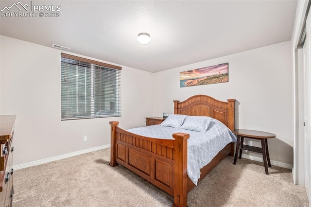 bedroom featuring light carpet