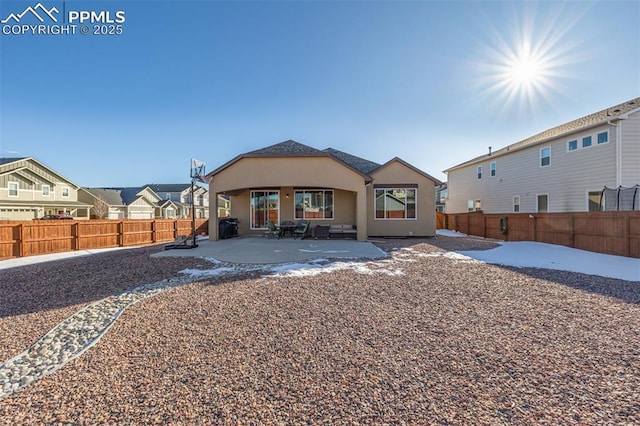 rear view of property featuring a patio area