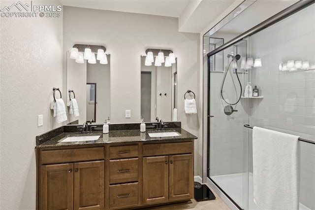 bathroom with vanity and a shower with shower door