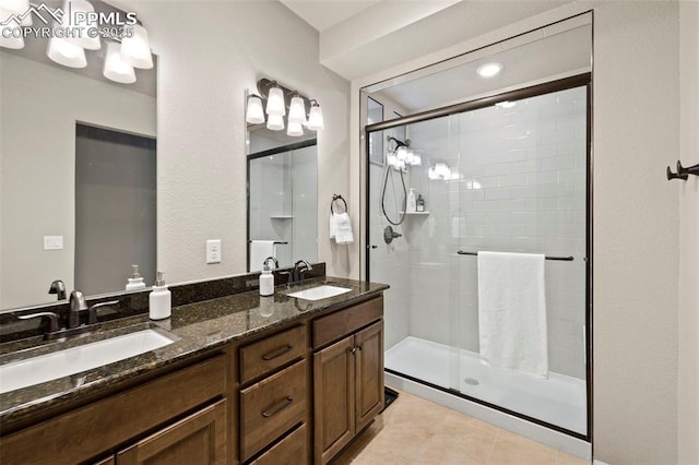 bathroom featuring vanity, tile patterned floors, and a shower with door