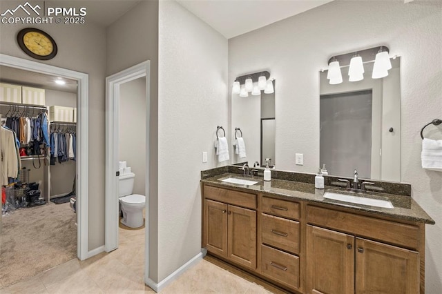 bathroom with vanity, tile patterned flooring, and toilet