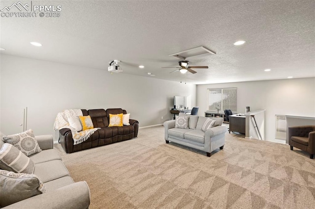 carpeted living room featuring ceiling fan and a textured ceiling