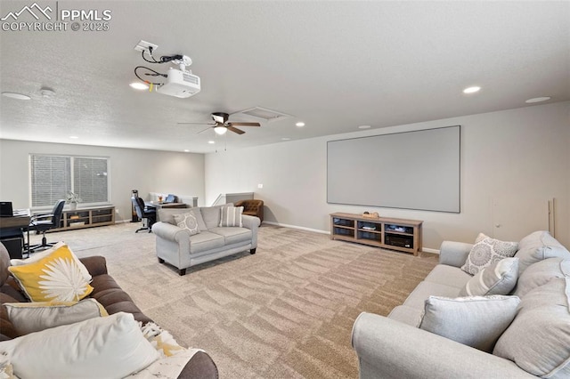 carpeted cinema featuring ceiling fan and a textured ceiling