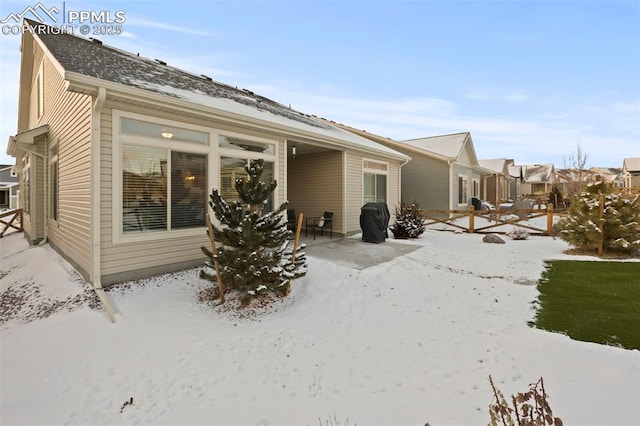 view of snow covered rear of property