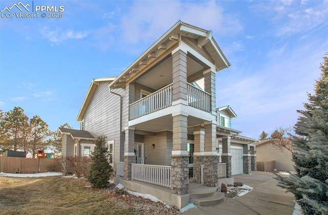 view of front of house featuring a balcony and a garage