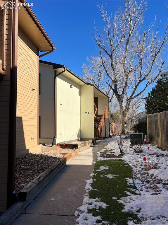 snow covered property with a patio area