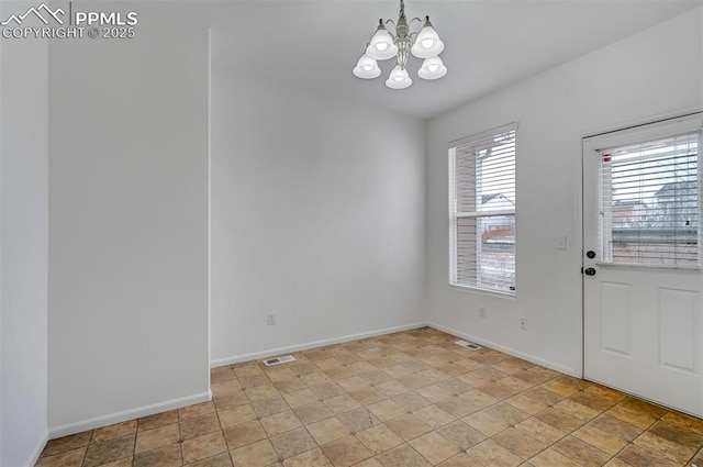 tiled entryway with an inviting chandelier