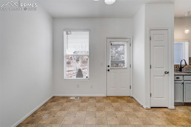 tiled foyer featuring sink