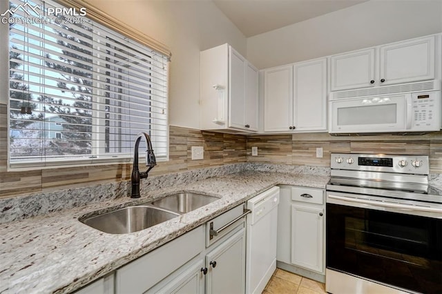 kitchen featuring sink, white appliances, light stone counters, and white cabinets