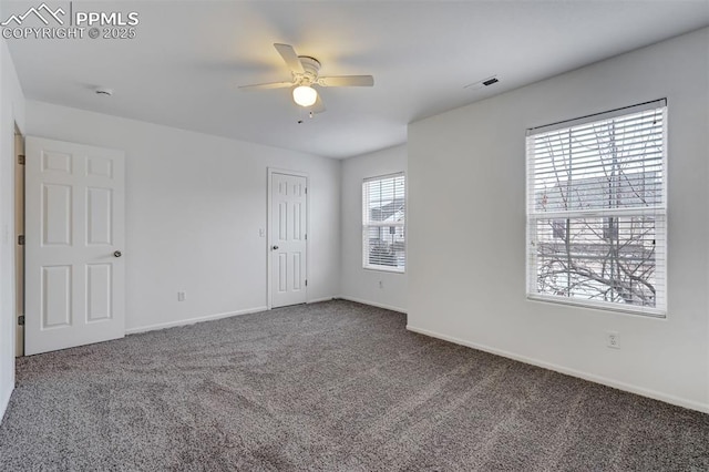 carpeted spare room with ceiling fan