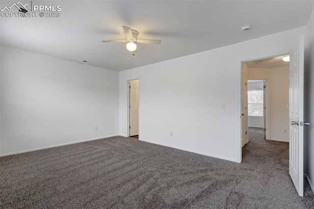 spare room with ceiling fan and dark carpet