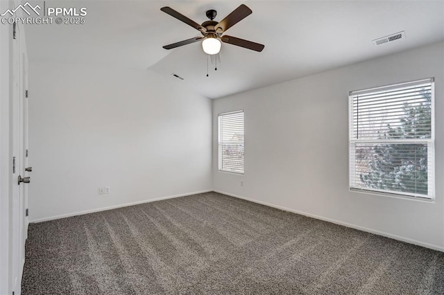 unfurnished room featuring ceiling fan and dark carpet