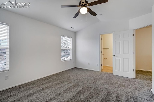 carpeted empty room featuring lofted ceiling and ceiling fan